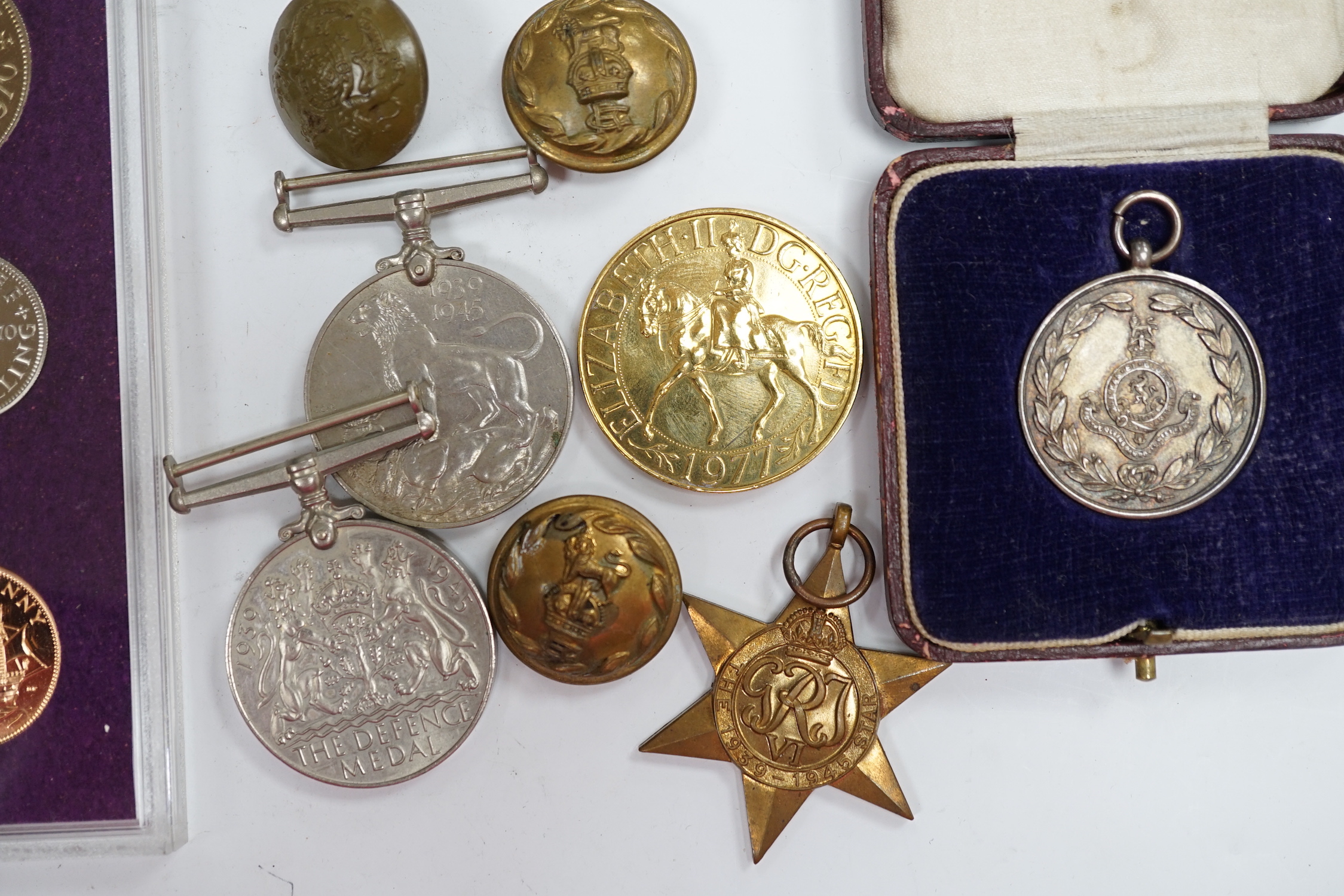 A collection of medals and coins including; an original card Air Ministry box containing a 1939-45 star and a 1939-45 medal in their greaseproof envelopes, together with a further Defence medal, a 1939-45 medal, a cased